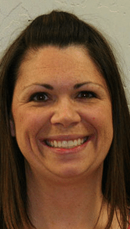 Adult woman with improved smile after orthodontic treatment.